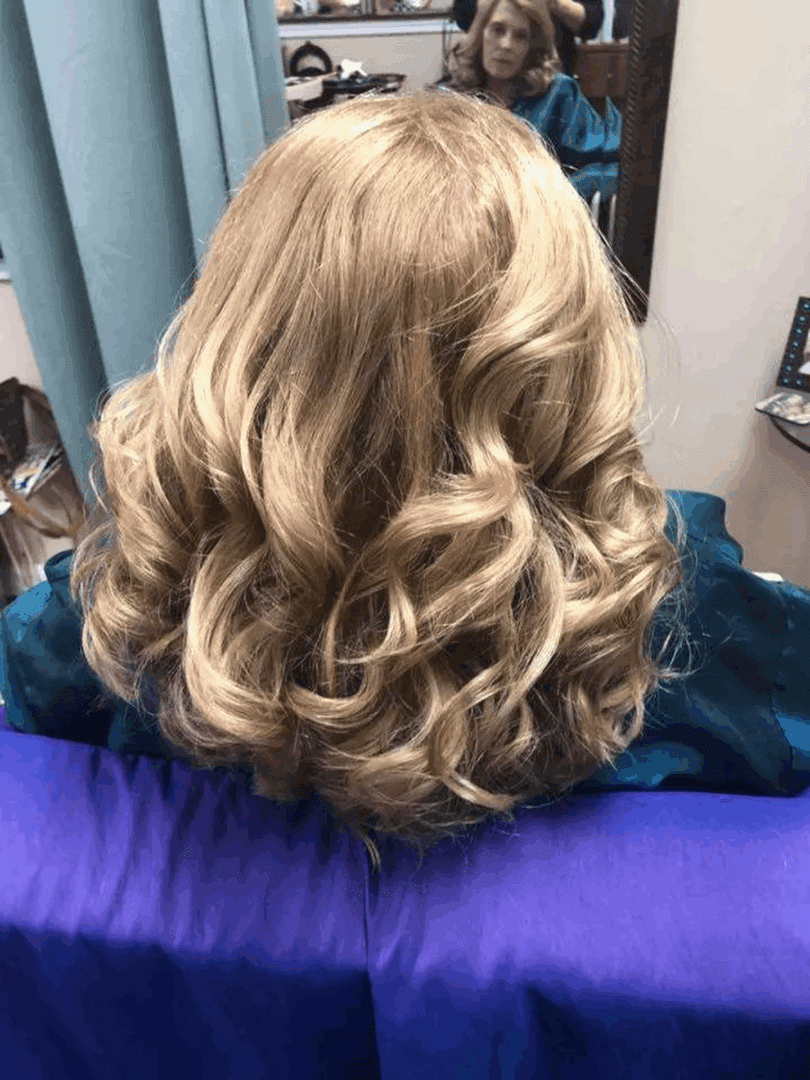 Blonde hair with soft curls in salon