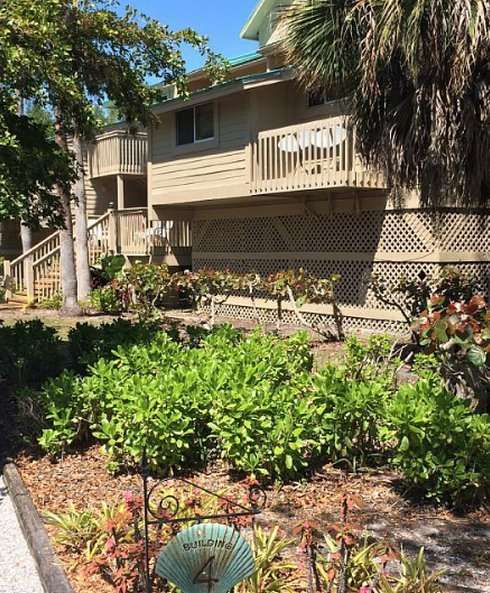 Apartment building surrounded by lush greenery