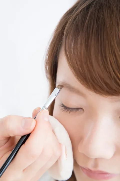Applying eyebrow makeup with brush