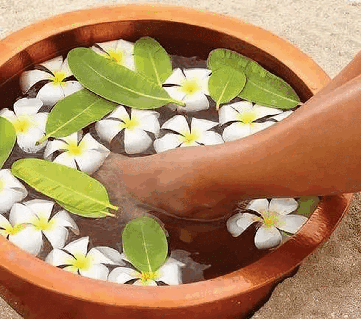 Foot in floral spa bowl