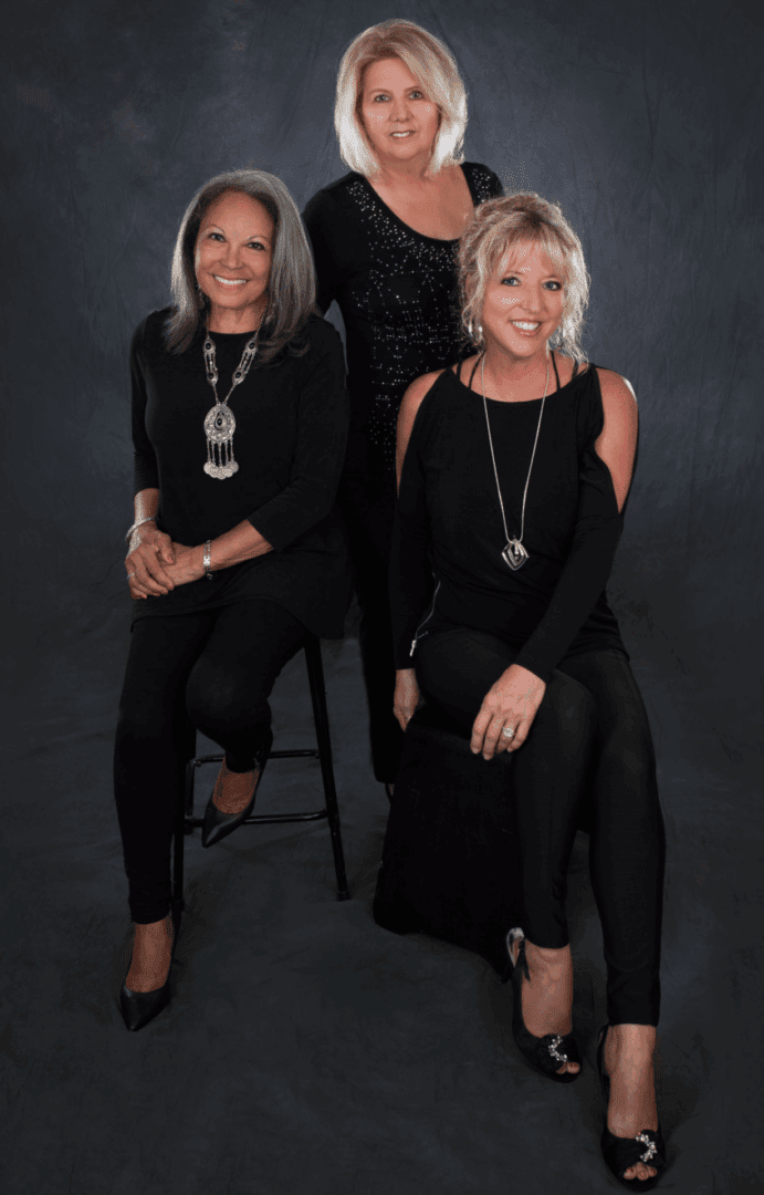 Smiling women in coordinated black attire