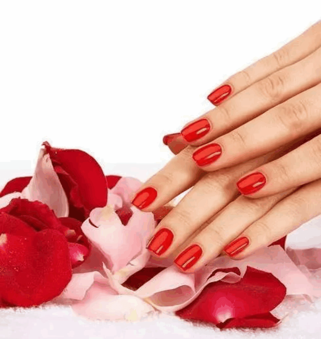 Red manicured nails with rose petals